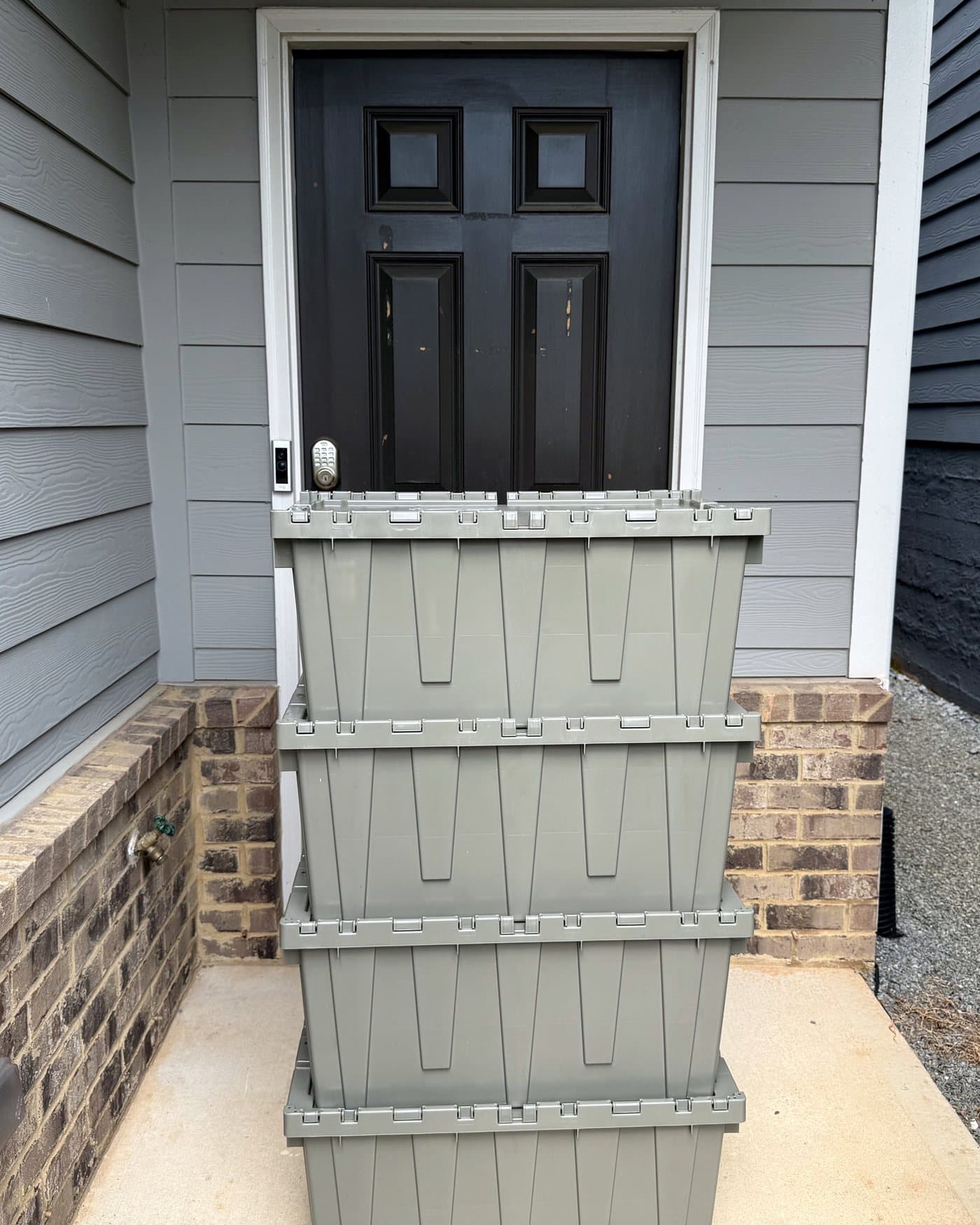 A stack of four Cherokee Crate totes squared up at a customer's front door