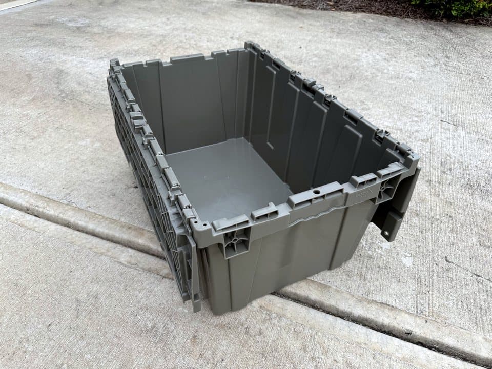 A Cherokee Crate tote open on a driveway with its lid folded out to the sides